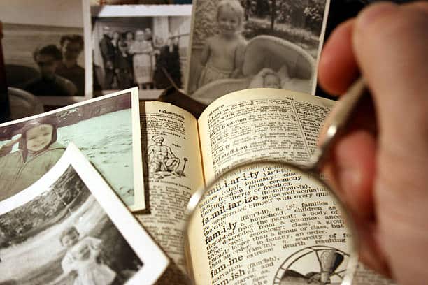 antique dictionary pictured with magnified definition of "family" or more